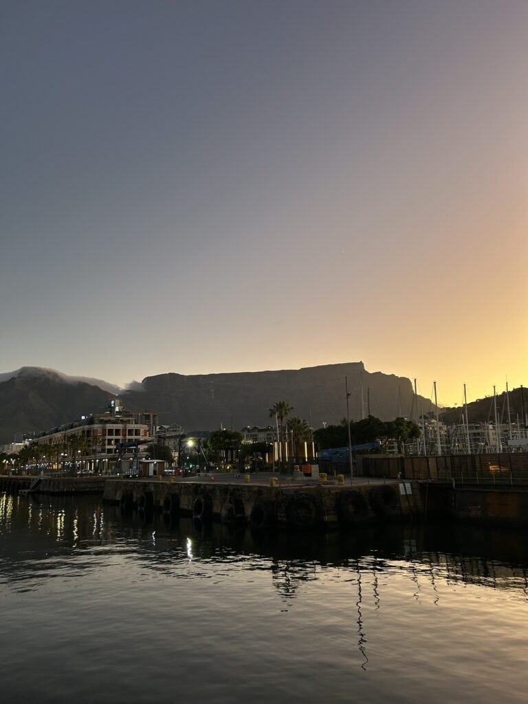Image of Table Mountain with the sunset behind it, taken from the harbour